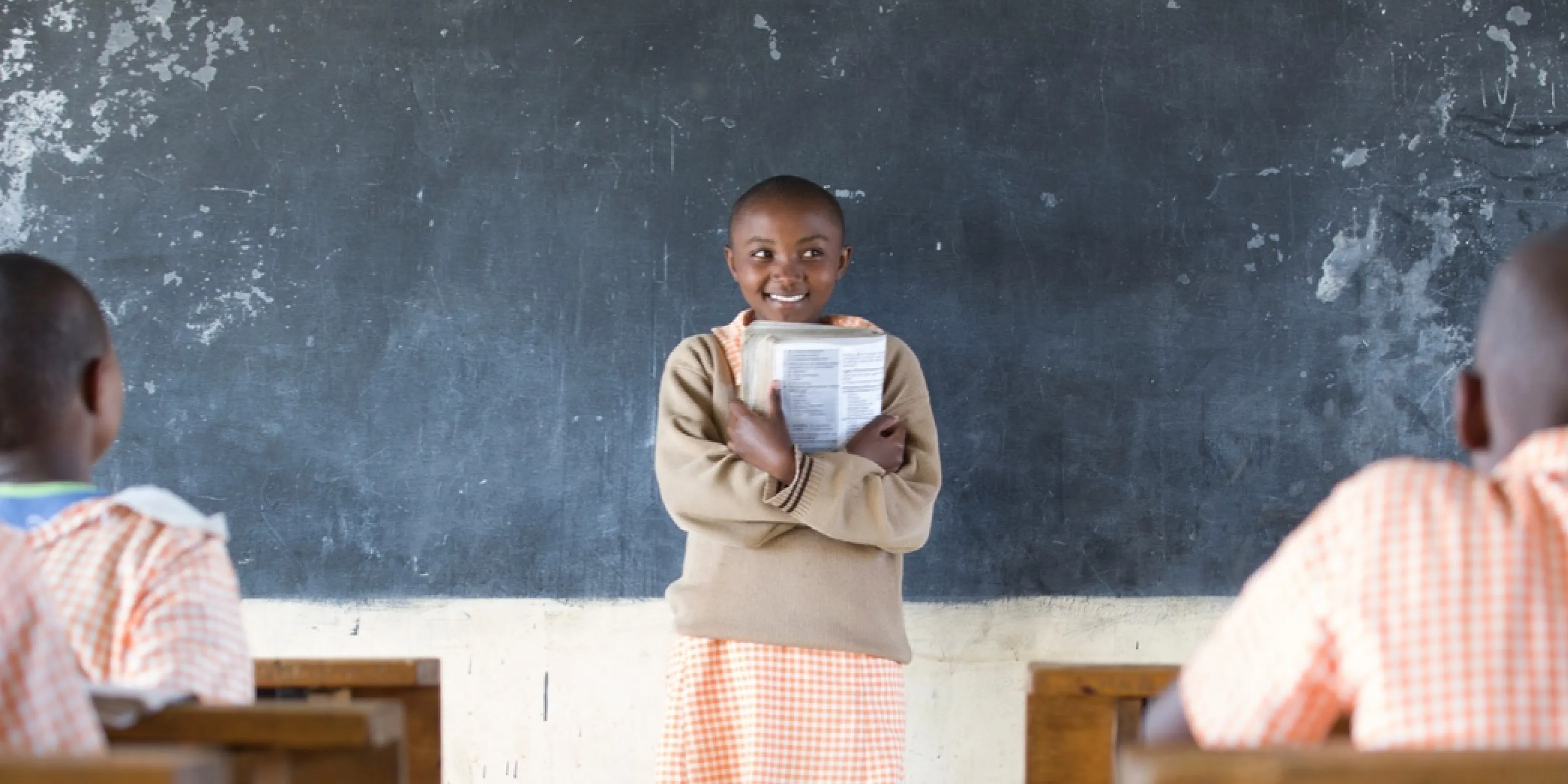 Girl standing in front of a classroom